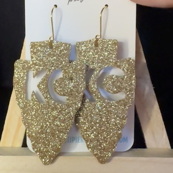 Slowly showing the sparkle of KC Cutout Arrowhead Earrings