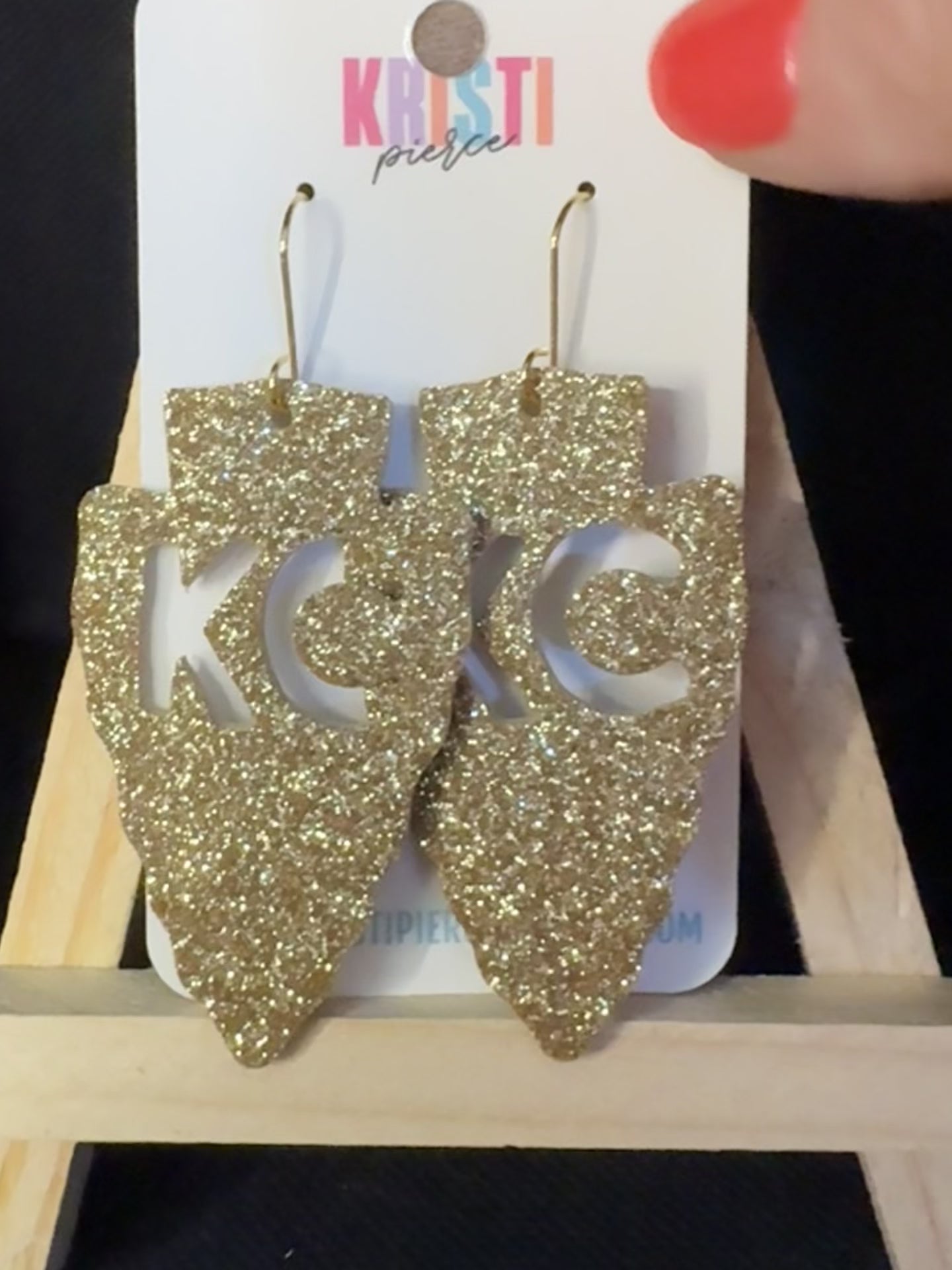 Slowly showing the sparkle of KC Cutout Arrowhead Earrings